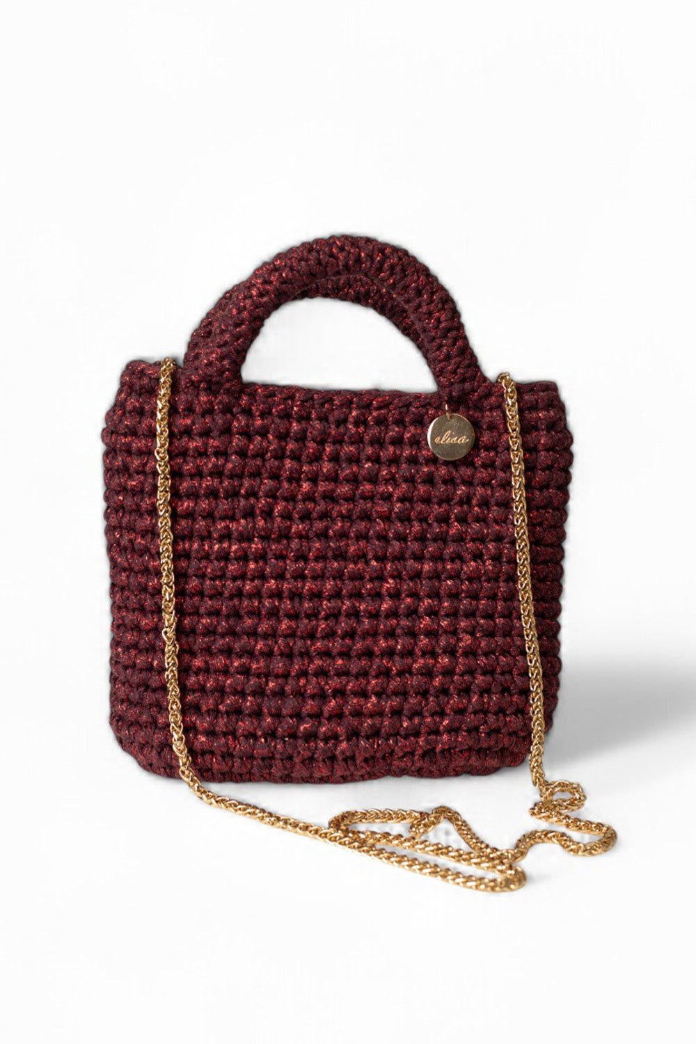Cartera tejida color guinda  metalizado.